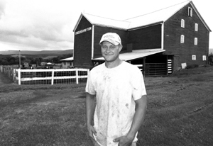 Adam Egolf continues the tradition of the family farm. He is standing outside the beef finishing barn at the Lincoln Highway Farm, Schellsburg.