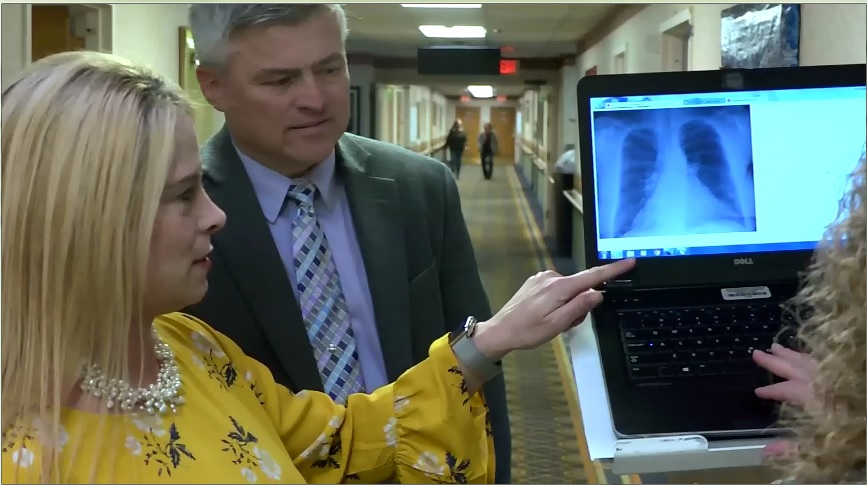 Rebecca Mundorff of Pennknoll Village shows Mark Bollman of Bedford County Technical Center an X-ray during the filming of the BCTC video. 